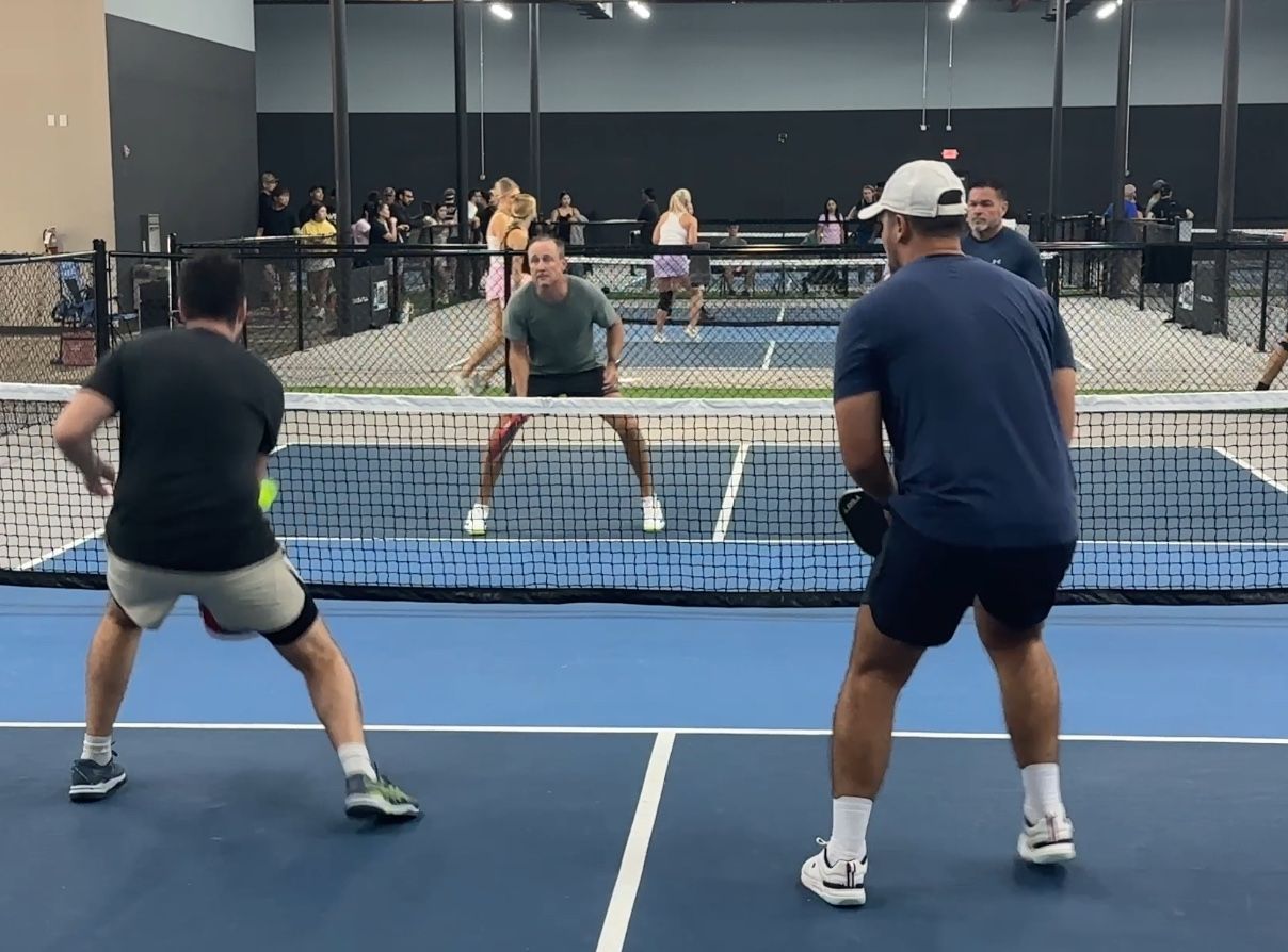 Doubles team set side by side at the kitchen line